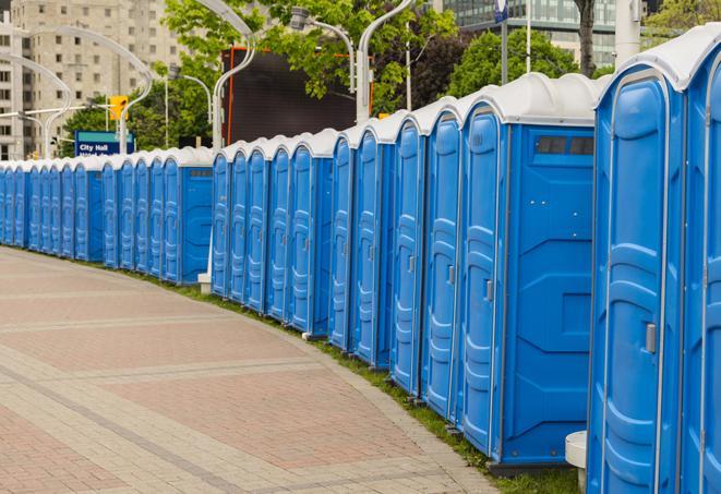 a row of portable restrooms set up for a large athletic event, allowing participants and spectators to easily take care of their needs in Arcadia